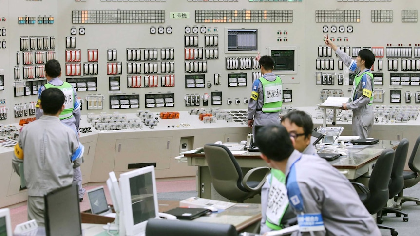 Employees of Kyushu Electric Power restart operations inside the central control room at Sendai nuclear power station