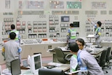 Employees of Kyushu Electric Power restart operations inside the central control room at Sendai nuclear power station