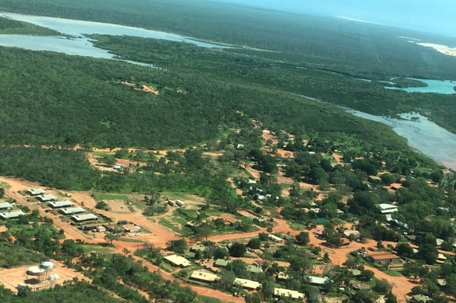 Aerial view of the community of Djarindjin, surrounded by bushes and water.