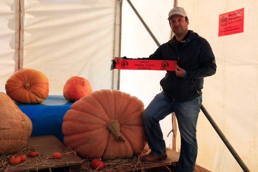 Derek Foster poses with his pumpkin.