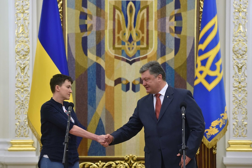 President Petro Poroshenko shakes hands with Nadiya Savchenko.