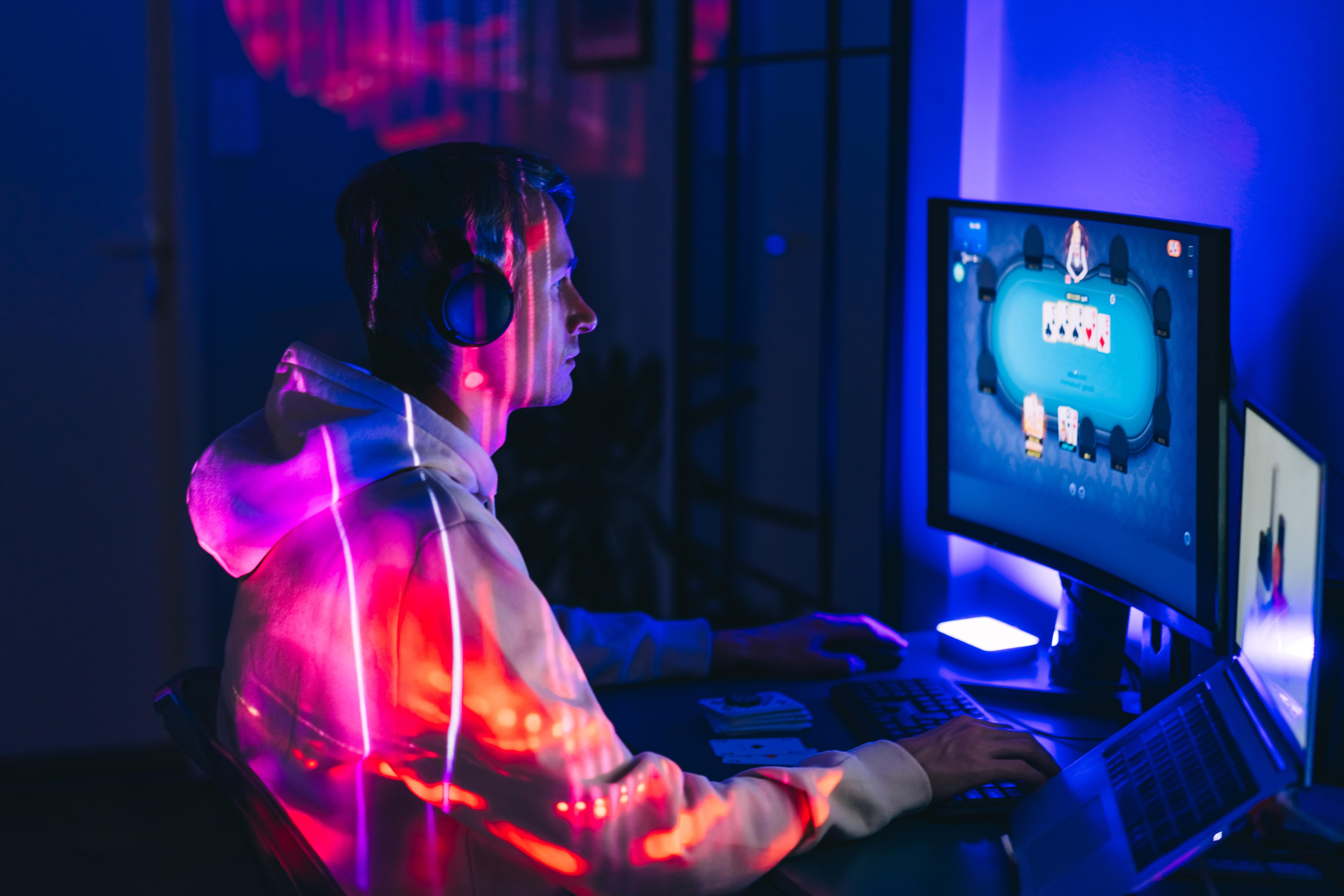 A mid adult man playing poker online