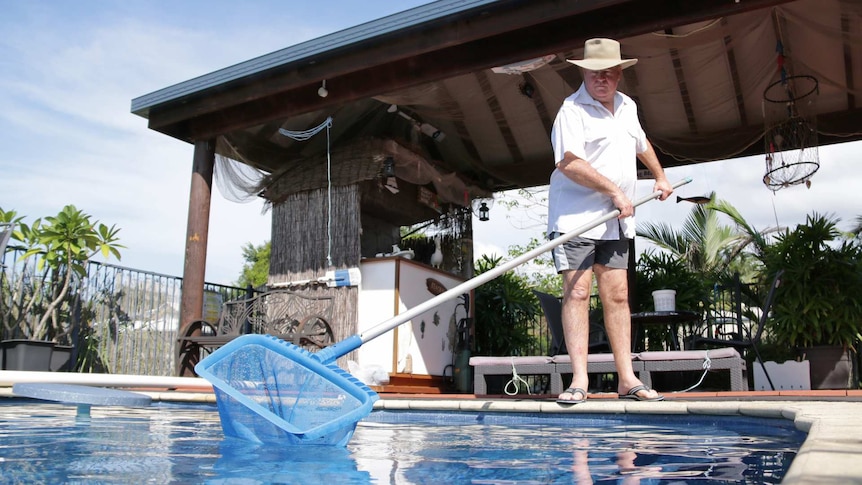 Ron Clay cleans the pool at his Highvale home.
