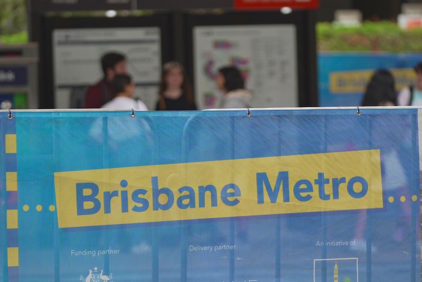 A yellow and blue sign reads "Brisbane Metro".
