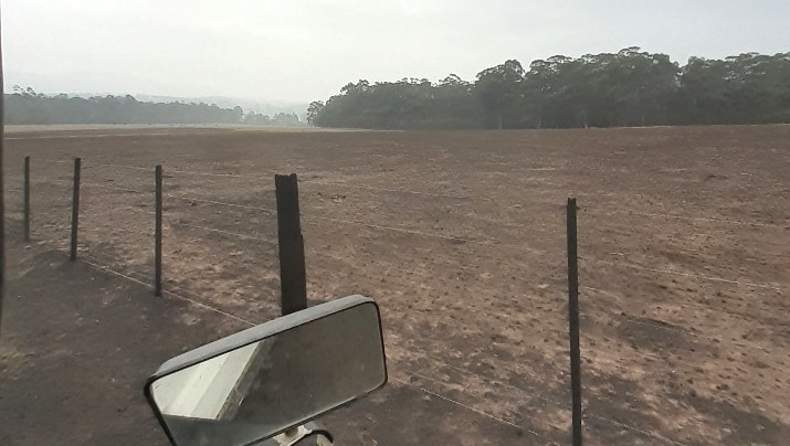 View of a burnt farm fence and paddock in far East Gippsland.
