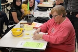 A woman tallies votes in the Iowa caucus at the King Elementary School in Des Moines, Iowa.