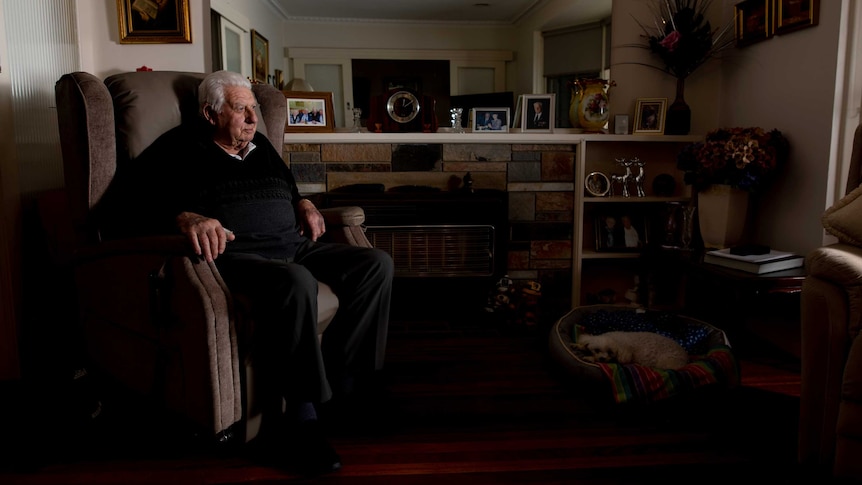 Roy McDonald sits in a chair and looks at the camera in his Melbourne home.