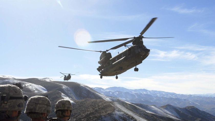 US troops in Afghanistan with Chinook helicopters overhead