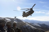 Nice pic of US troops (unidentifiable) standing on mountain side with Chinook helicopters