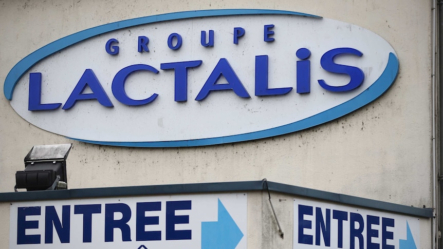 a exterior image of a Lactalis factory with the company's logo on the wall and a sign pointing to the entrance