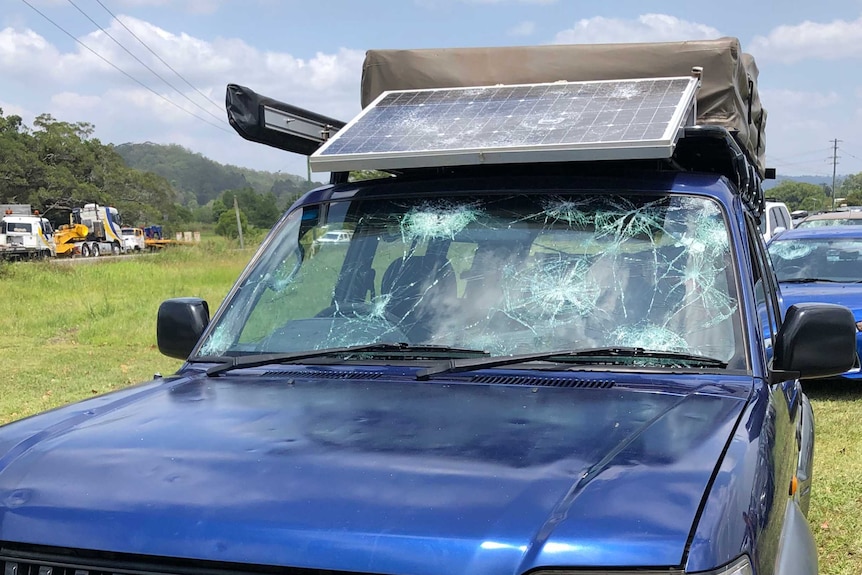 A four-wheel drive with a smashed windscreen and a damaged rooftop solar panel.