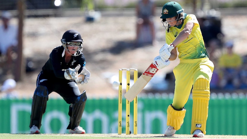 Meg Lanning plays a shot on the off side with her back leg bent, head over the ball