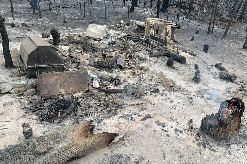 Embers still burn on Sharon Spedding's home on Tableland Road at Mount Maria.