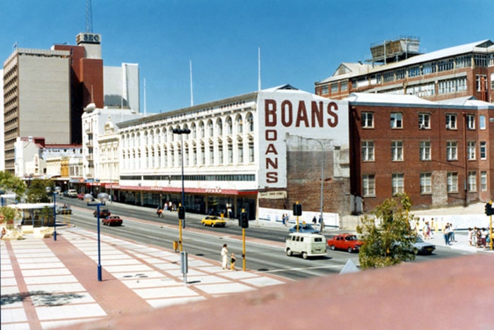 The Perth city Boans store building and surrounding streets, with cars and pedestrians.
