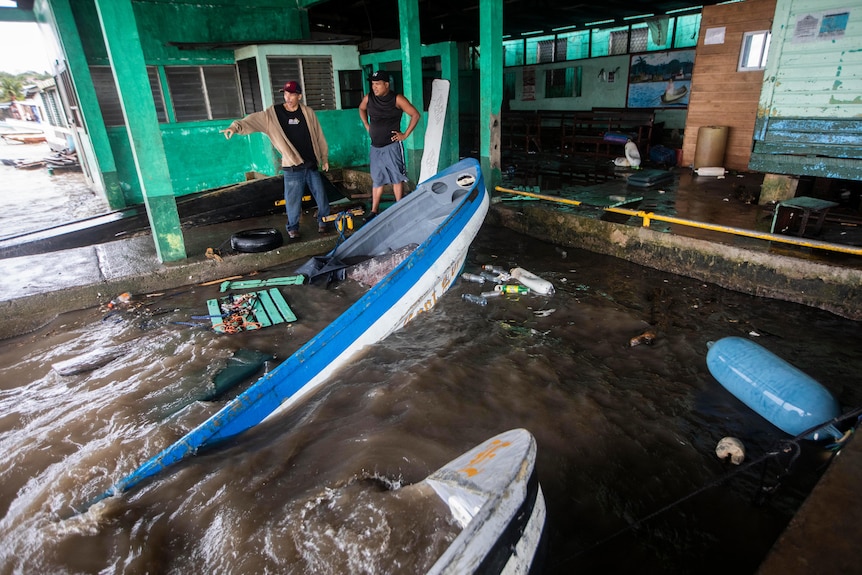 Boats submerged in water after hurricane. 