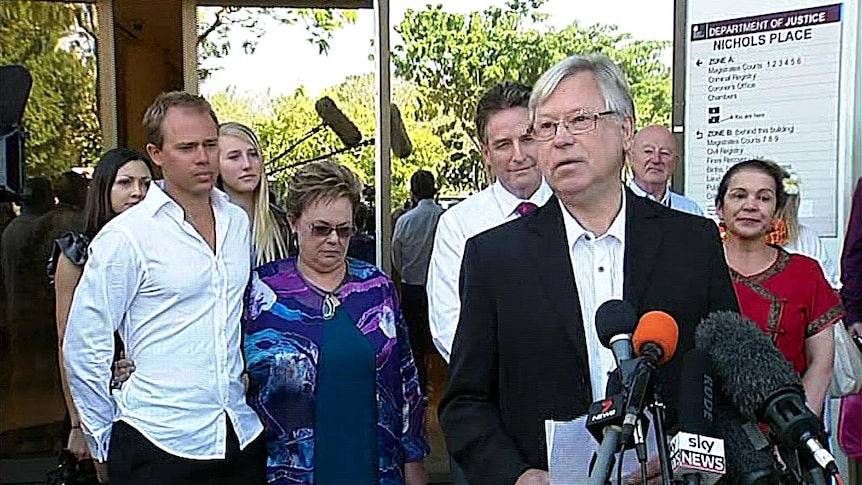 Michael Chamberlain speaks outside inquest as Lindy Chamberlain-Creighton and Aiden listen.