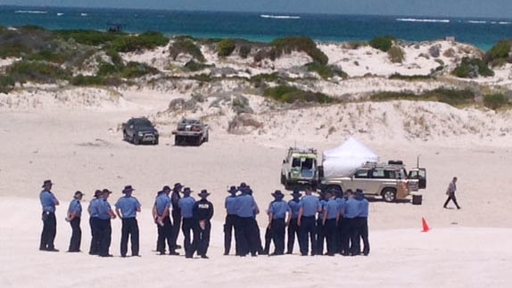 Vehicles and police surround a tent in Wedge Island sand dunes where 20-year-old man was found stabbed to death.