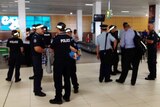 Some of the 700 extra police arriving at Cairns Airport for the G20 finance summit.