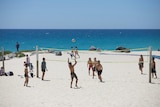 People playing volleyball on the sand at the beach