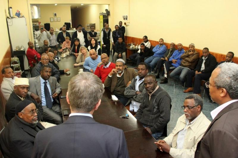 A room full of Somali community leaders looks up at Bill Shorten and Dr Hussein Haraco.