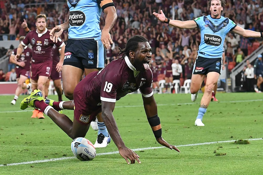 Edrick Lee dives forward with his tongue out as two Blues players appeal in the background