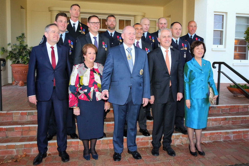The rescuers pose for a group photo with the Prime Minister, Opposition Leader and Governor-General.