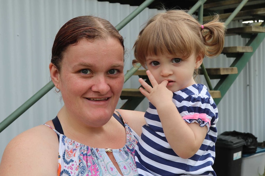 A mother holds a toddler