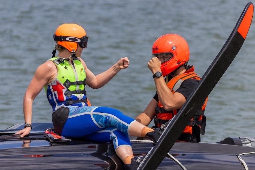  Maddi Boyer fist-bumping fiance on the water