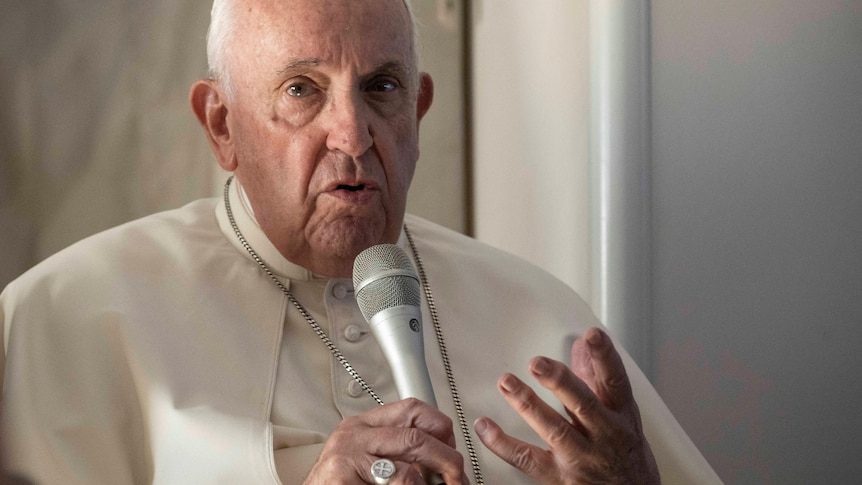 Pope Francis answers reporters' questions during his flight back to Rome.