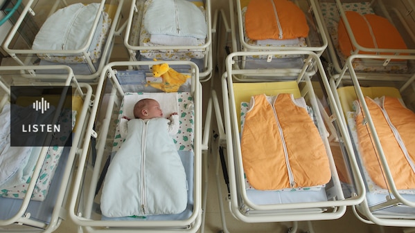 A newborn baby among empty baby beds in a German hospital. Has Audio.