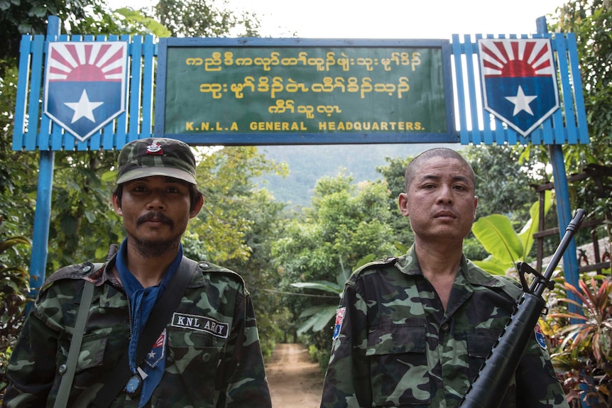 Soldiers from the Karen National Liberation Army looking determined in front of their headquarters.