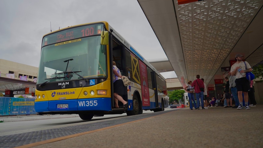 A person boarding a bus in Brisbane.