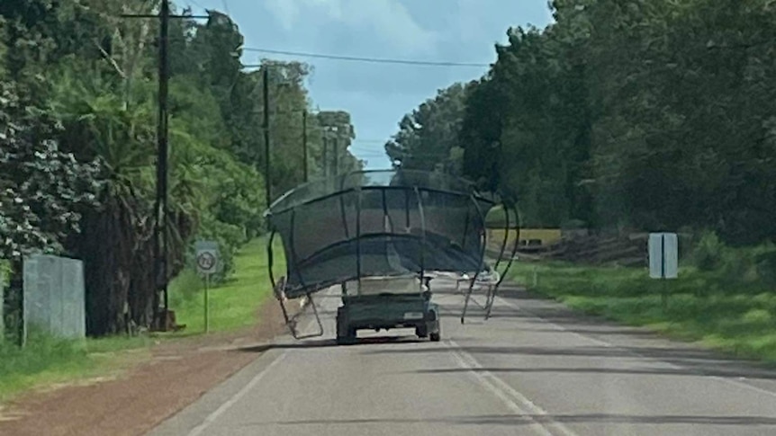 Trampoline on the back of a vehicle on a bitumen road