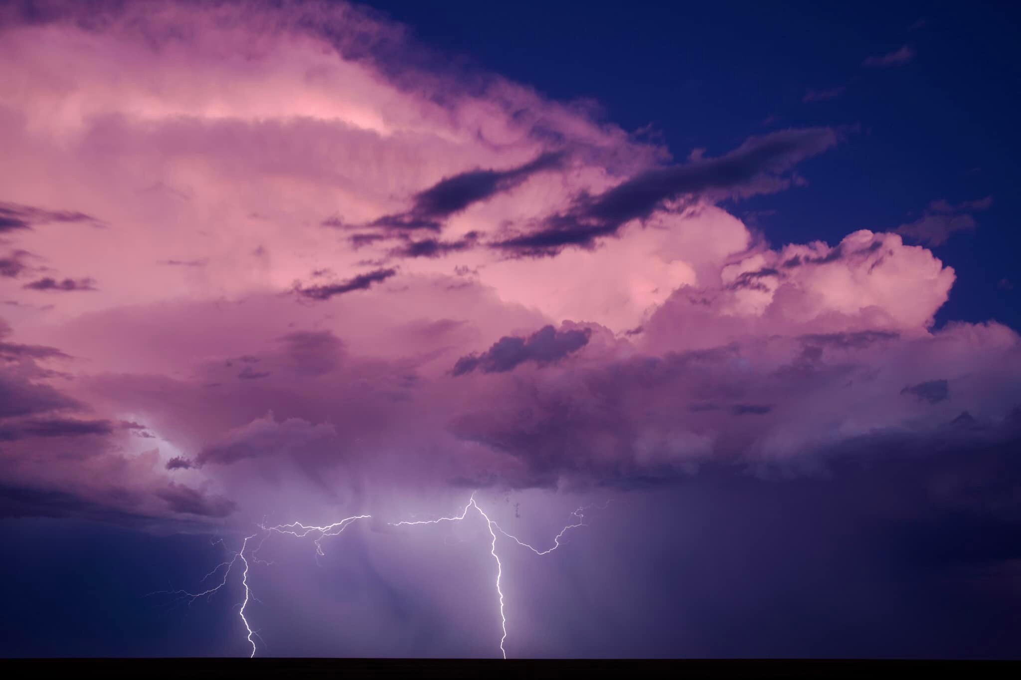 Purple hues on clouds with lightning