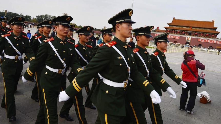 Paramilitary police walk through Tiananmen Square in Beijing