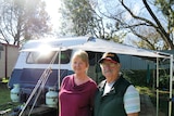 Gary and Jane out the front of their caravan