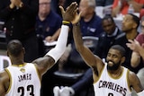 Cleveland Cavaliers' LeBron James (23) and Kyrie Irving (2) high five during second half of game three of NBA finals.