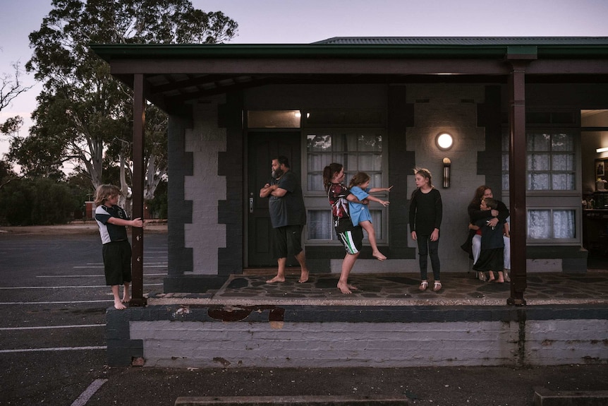 Children play outside an Adelaide motel room
