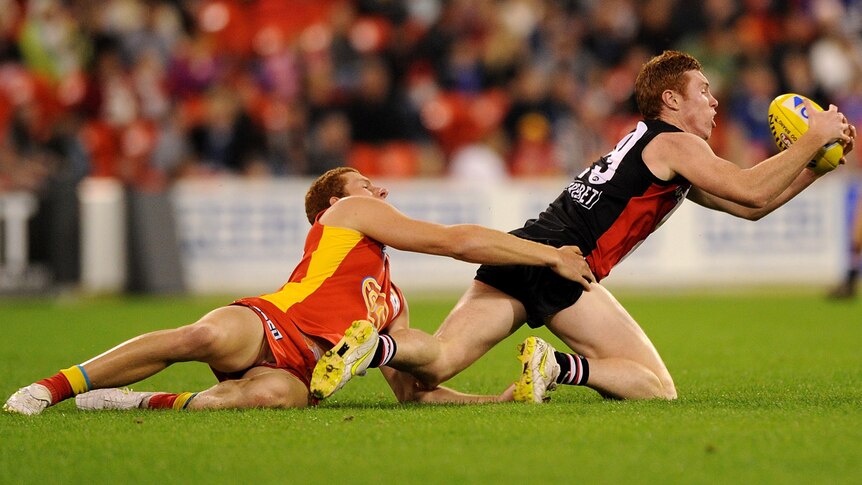 Tom Lynch of the Saints marks ahead of Rory Thompson of the Suns