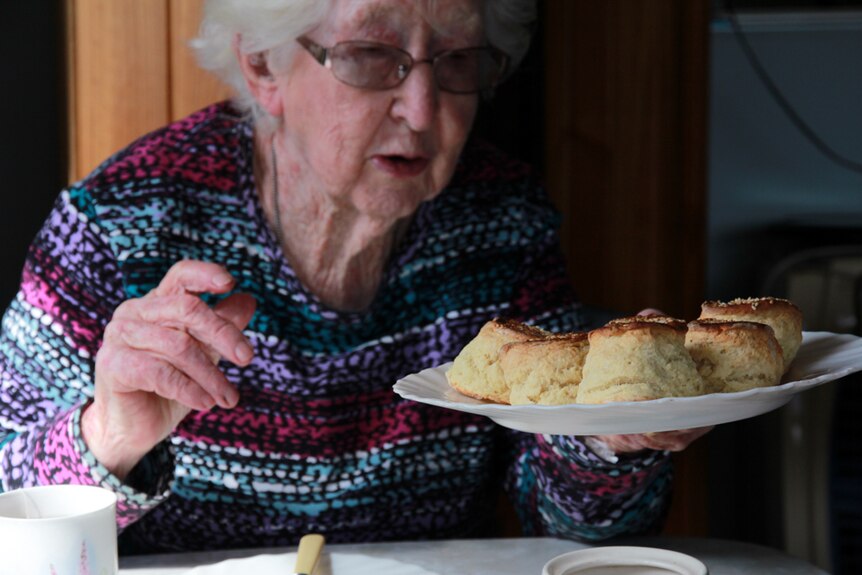 Betty Watt holding a plate of homemade scones