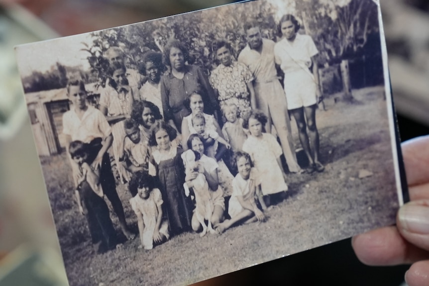 Patsy Brown holds an old family group photo of her father and his Aunty Mabel.