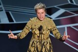 Frances McDormand on stage speaking into the microphone