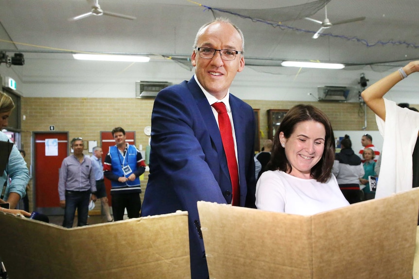 Labor Luke Foley with wife Edel as she casts her vote in the NSW election