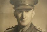 Staged vintage portrait of a young military man in uniform 