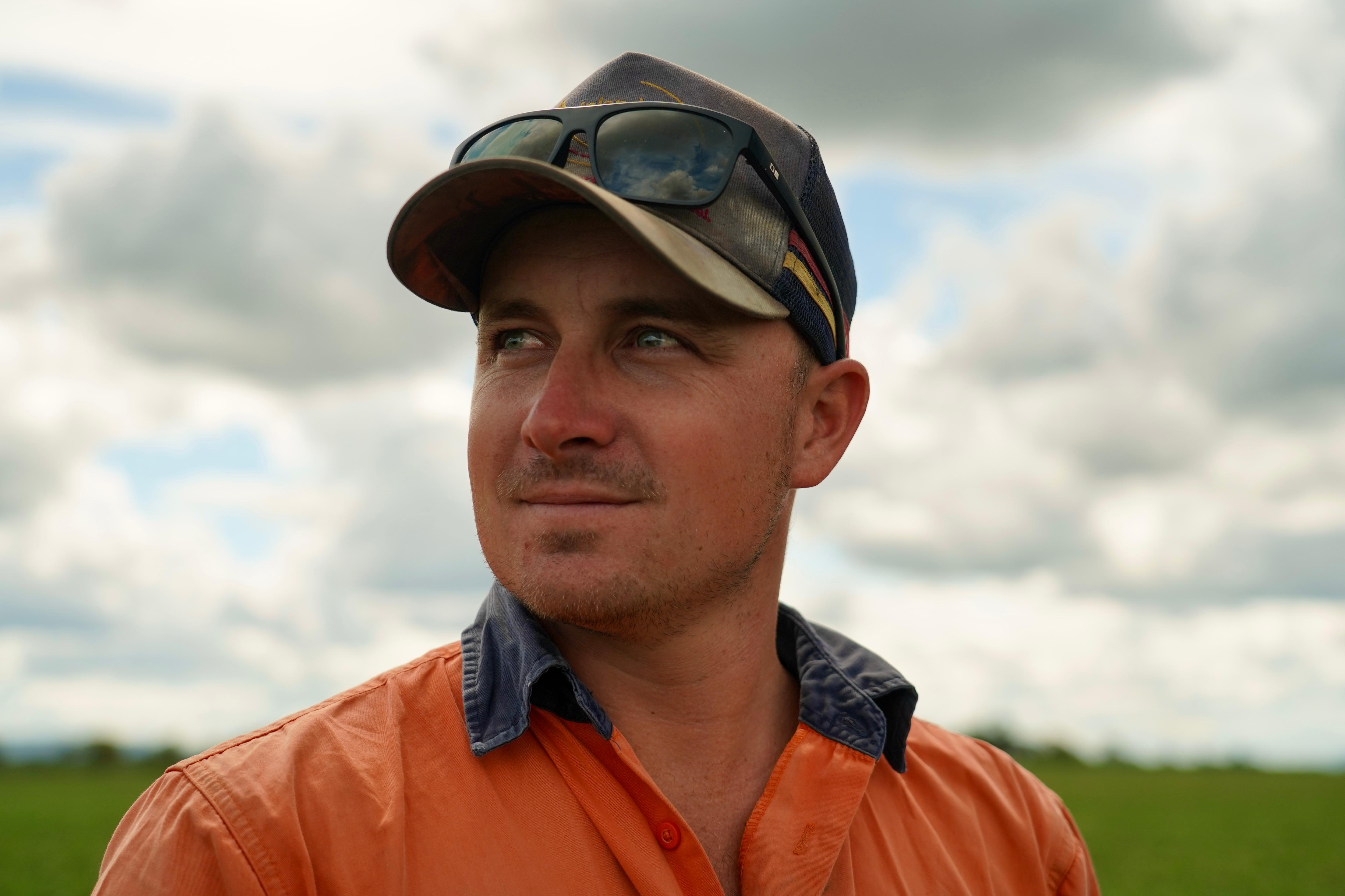 Man wearing cap and in orange shirt