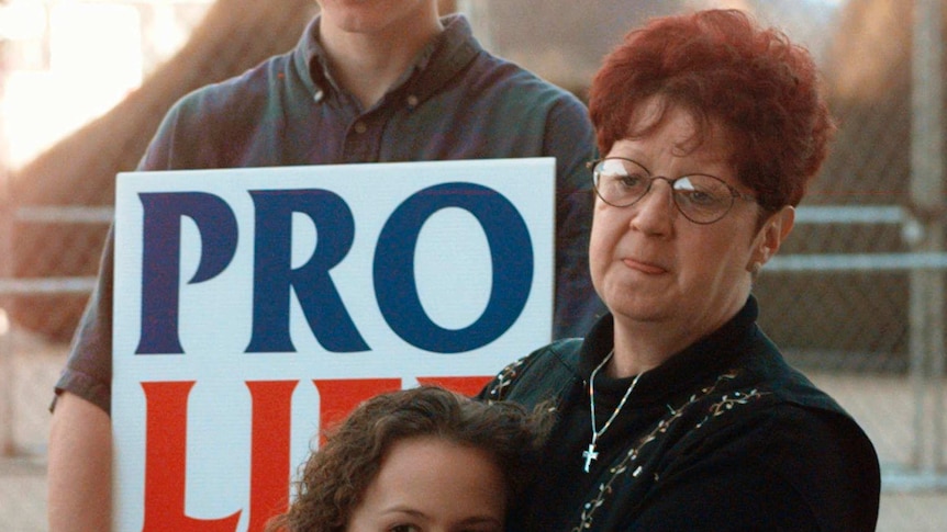 Norma McCorvey holds her friend meredith Champion at an operation rescue rally in dallas