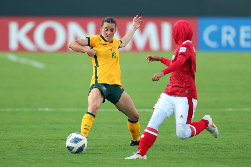 Women football players compete for the ball at the Asian Cup