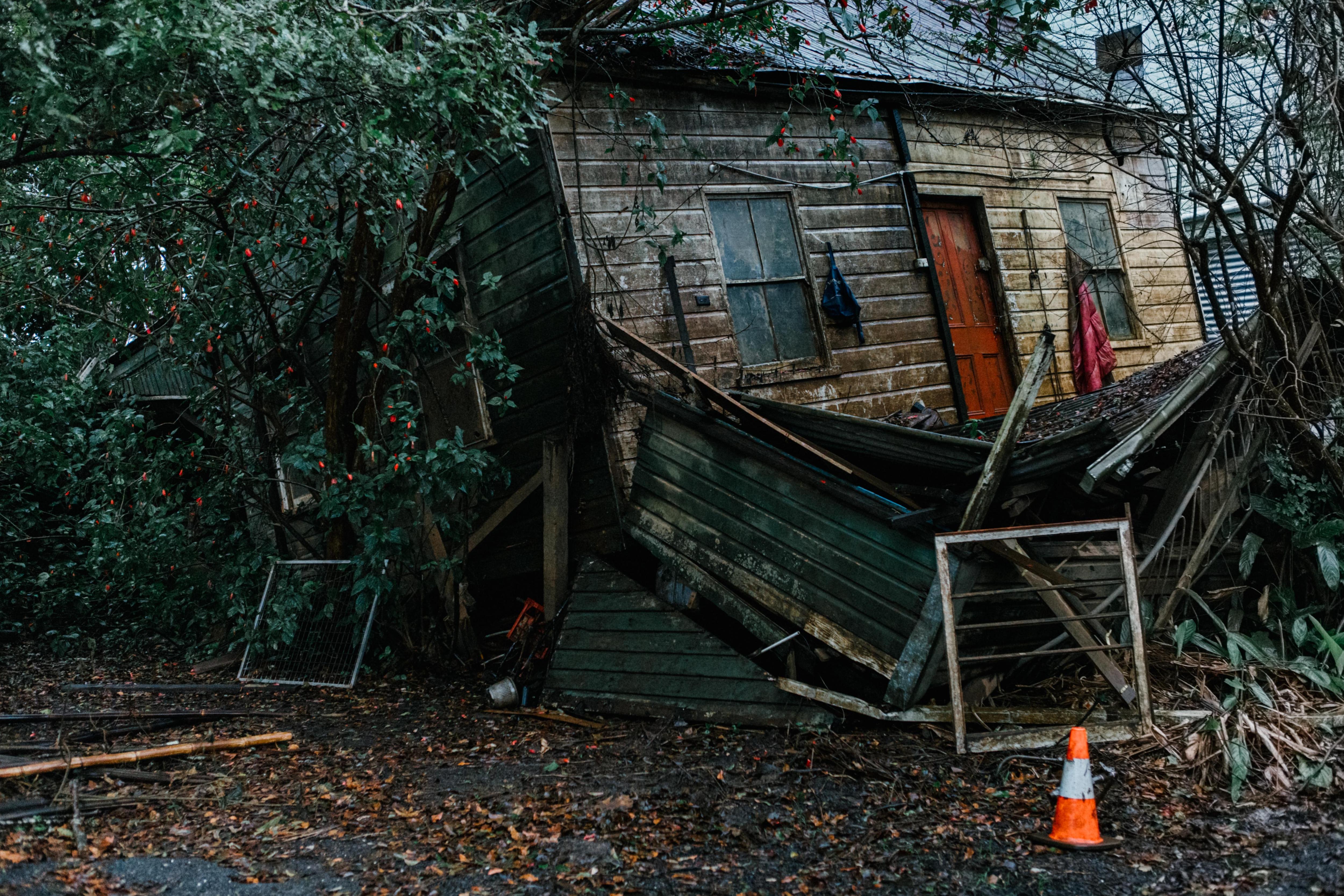 A dilapidated house covered in mold and grime 