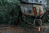 A dilapidated house covered in mould and grime 