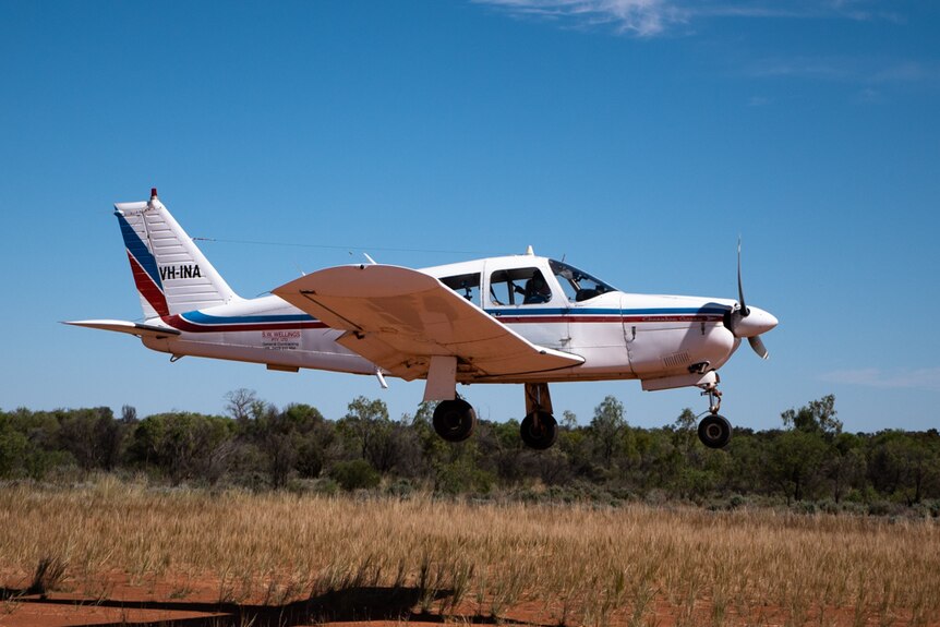 A small white plane captured moments after take-off in outback New South Wales.